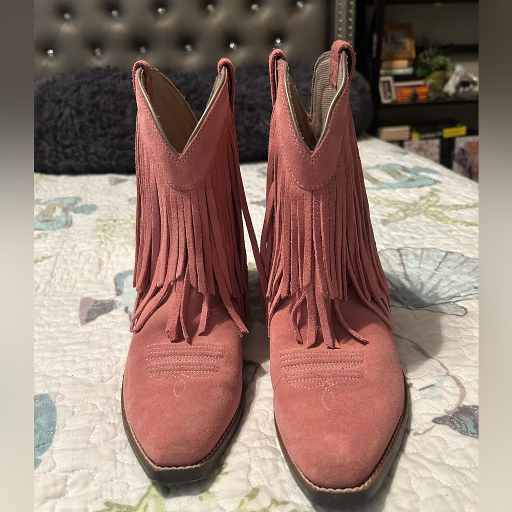Pink Ariat cowgirl boots with fringe.